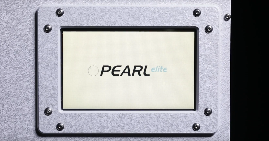 A close-up of a textured light gray panel with a central square inset displaying the brand name &